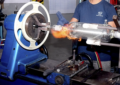 Glassware being shaped by hand
